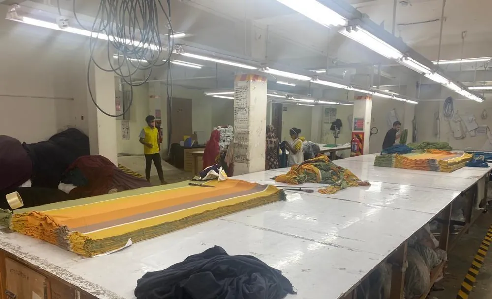 Cutting section with spread fabric and marker checking in progress