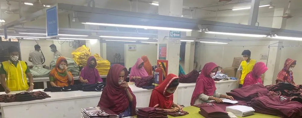 Operators steam pressing and finishing knitwear
