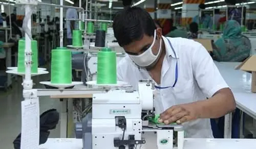 Close-up of an operator stitching a seam on an industrial machine